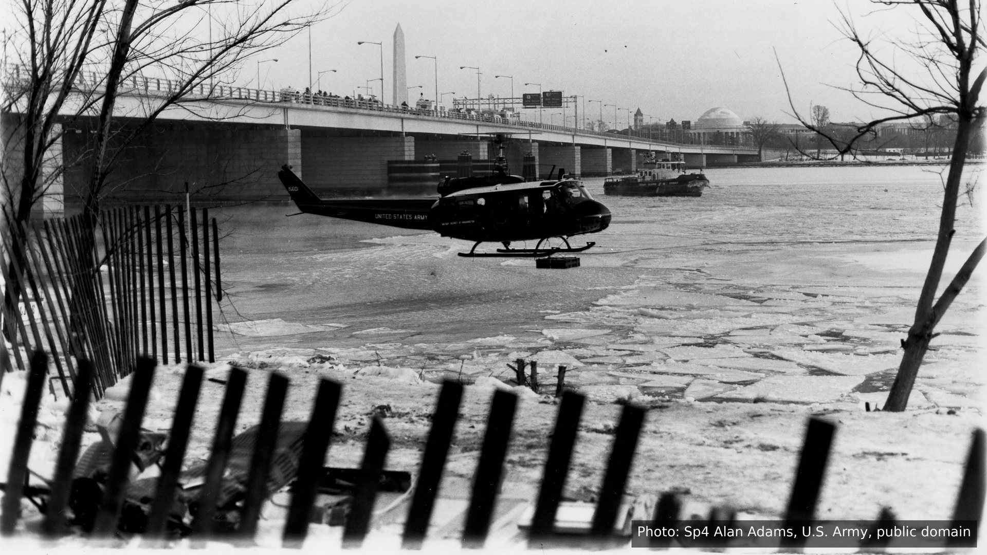 A helicopter over the frozen Potomac River beside the 14th Street Bridge, January 1982