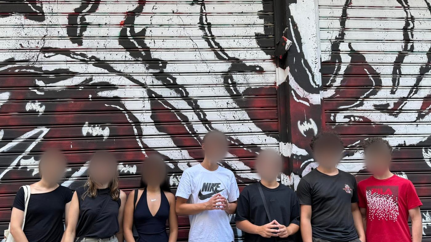 Students at a graffiti wall in Athens