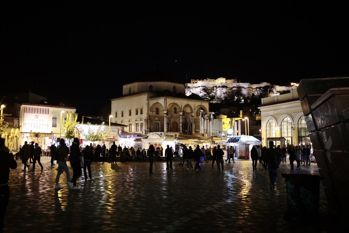 Monastiraki Square at night, with the Acropolis glowing above
