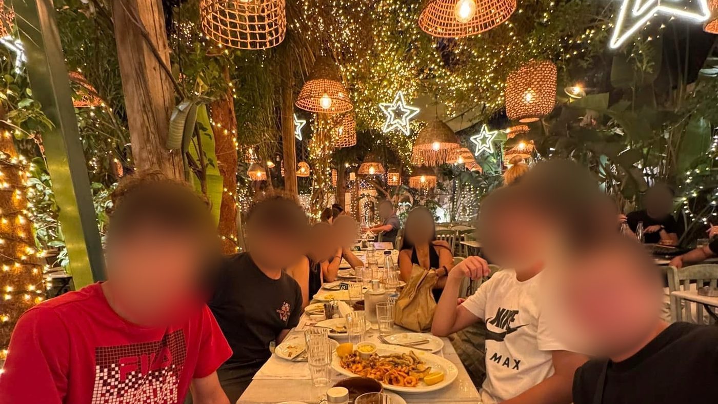 Dinner together in a taverna lit with fairy lights in Athens