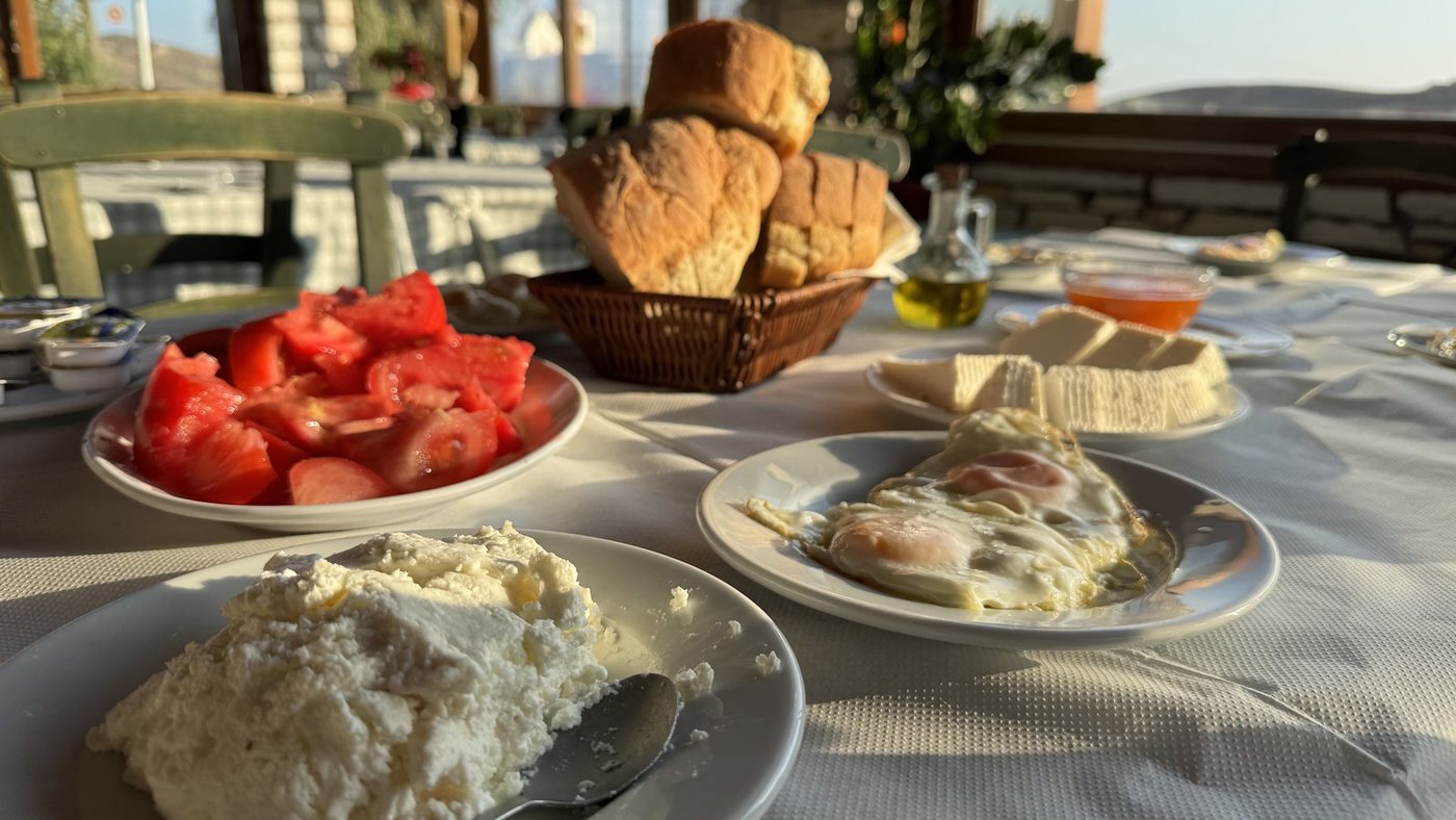 A typical Naxian breakfast: fresh cheese, fried eggs, tomatoes and village bread