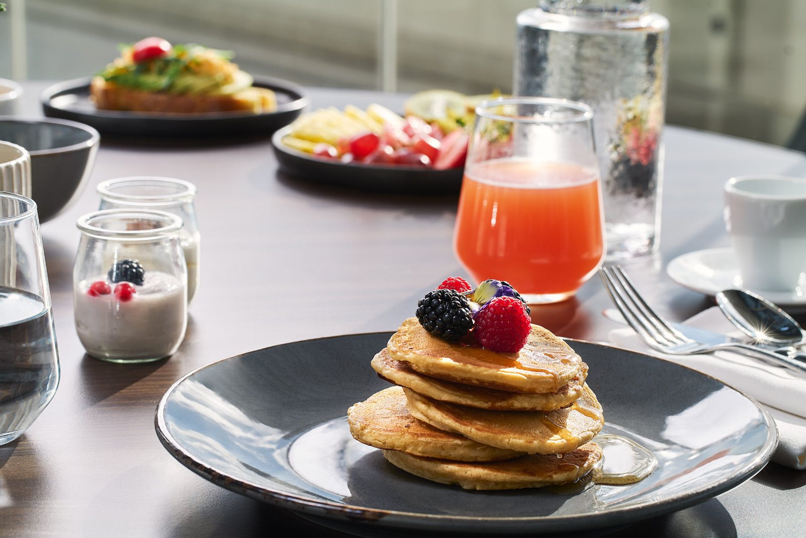 Pancakes with fresh berries and juice at breakfast, Athens