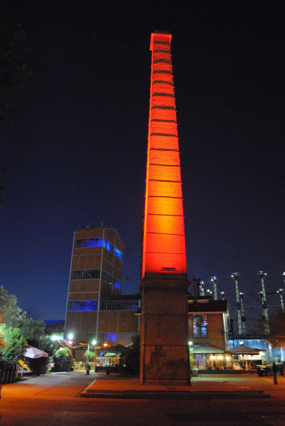 Gazi at night: the red-lit chimney of the old gasworks
