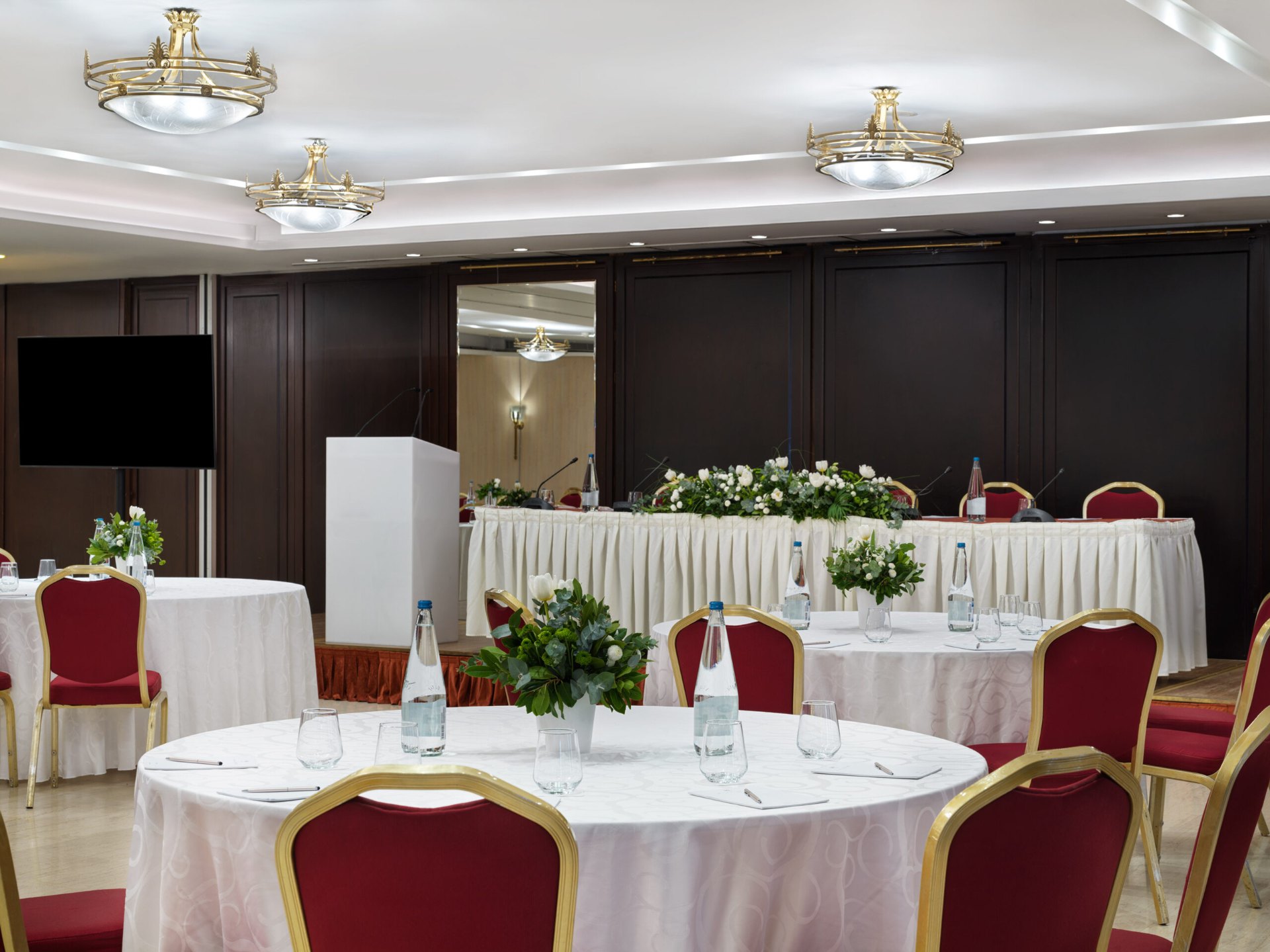 Round tables with notepads and water, ready for a workshop
